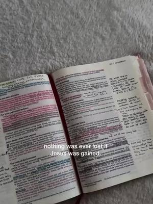 An open Bible lies on a plush, textured surface. The pages are filled with handwritten notes and highlighted text in pink, blue, and yellow. The focus is on a quote overlaid on the image.