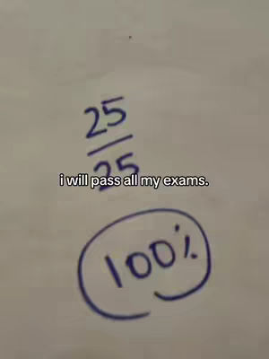 The cover image shows a close-up of a white surface with blue handwritten text and a circled number. The text reads "25/25", and "i will pass all my exams" is below these numbers. In the bottom right corner, a circle surrounds the number "100%". The image is simple, with the focus on the text and numbers, and the color scheme is primarily white and blue.