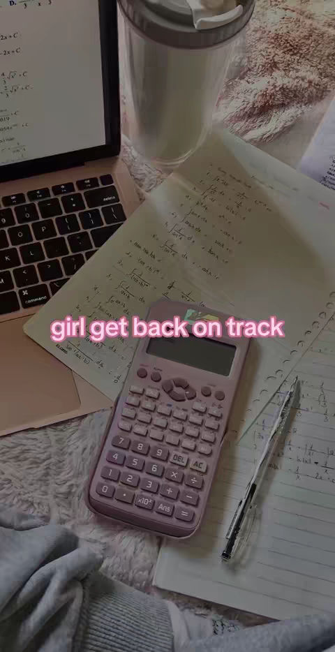 The cover image depicts a desk setup with a laptop, open notebook filled with handwritten equations, a calculator, pen, and a clear tumbler. The text overlay reads 'girl get back on track,' written in a pink stylized font.