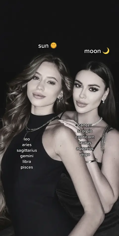 A grayscale image features two women in a close embrace. Sun and Moon symbols flank each woman vertically, with lists of zodiac signs to their sides.