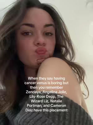 A selfie-style image with a young woman in the foreground. She is looking directly at the camera with a slight pout. Behind her, the background is blurred, suggesting a close-up shot. There is text overlayed on the image.