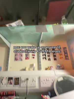 The cover image shows the POV of waking up as a year 12 student taking four STEM A levels. The view is from a low angle that shows a section with a bulletin board. There are images in the board with some text. Below, there are what looks like power outlets and a fragment of an edge of something rounded.