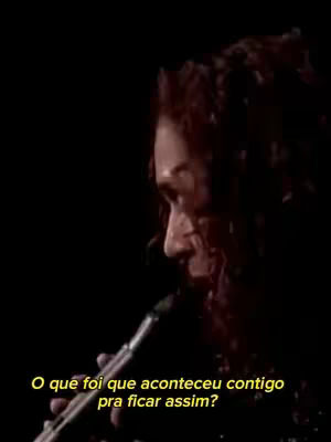 The cover image shows a person with dark hair, seen in profile. They are holding a microphone and looking to the side. Text in yellow font is overlaid at the bottom of the image.