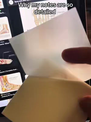 The cover image shows a hand lifting a piece of paper, revealing a screen displaying illustrated anatomy. The text overlay states "Why my notes are so detailed". The scene suggests a study or educational context.