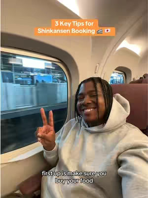 A selfie taken inside a train, featuring a person smiling and giving a peace sign with two fingers. The background shows a blurred view through the train window. On top of the image, there is an orange banner with the text '3 Key Tips for Shinkansen Booking' and a small Japanese flag.