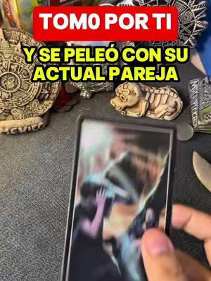 The image shows a person holding a card, possibly a tarot card, with a blurred image on it. The image is framed with items associated with spirituality and divination such as stone carvings. Text overlays are placed at the top of the image in a vibrant red box and above the image in a yellow box.