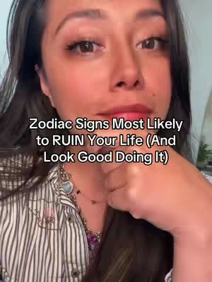 The cover image features a close-up of a woman with dark hair, looking towards the camera. Text overlayed on the image reads, "Zodiac Signs Most Likely to RUIN Your Life (And Look Good Doing It)". The woman is wearing a striped shirt and a necklace.