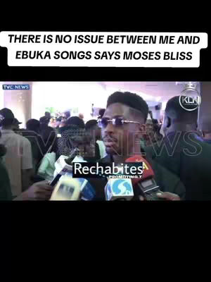 The cover image shows a man being interviewed, surrounded by a crowd of people and microphones from various news outlets. Text overlays at the top of the image state "THERE IS NO ISSUE BETWEEN ME AND EBUKA SONGS SAY MOSES BLISS". The man, wearing sunglasses and a stylish haircut, is the central focus, with the logo of TVC NEWS visible in the background. The scene is set in an outdoor location with a lot of people visible.