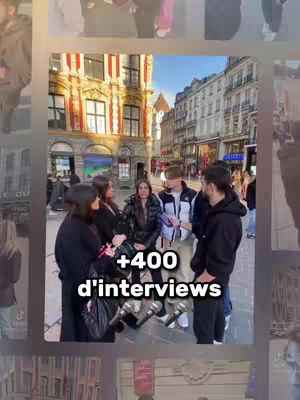 A group of people are gathered in a public space, possibly a street or plaza. Several individuals are holding microphones, suggesting an interview or a recording session. The background showcases urban architecture, including buildings with windows and architectural details. A text overlay indicates the number of interviews conducted.