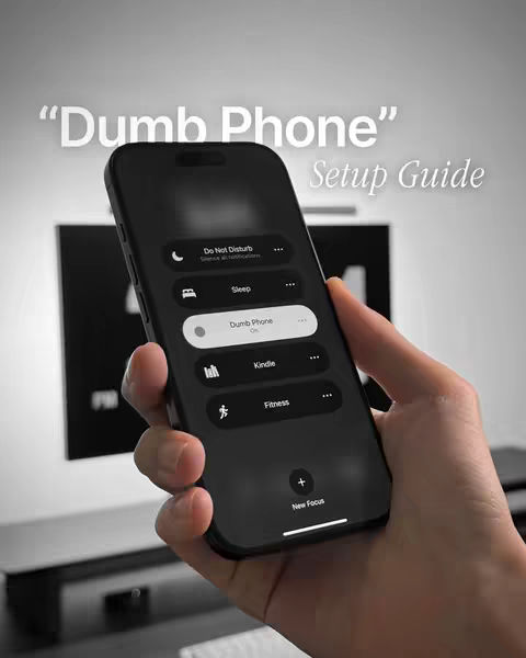 A person holds a black iPhone displaying the settings for the 'Dumb Phone' focus mode, with the title overlaid on the image.