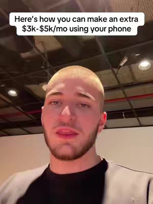 A man with a shaved head and a short beard is centered in frame, looking slightly to the side while talking. Overhead, a white bar contains text outlining the video's topic. The background includes a ceiling with industrial lighting.
