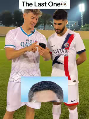 Two men in soccer jerseys stand on a grassy field, looking at a phone. An image of the top portion of a man's head is superimposed on the bottom, while a text overlay appears at the top.