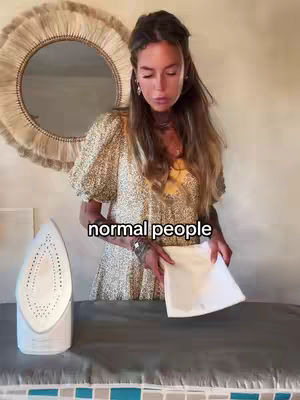 The cover image features a woman in a floral dress ironing on an ironing board. In the background, there's a large mirror. A text overlay reads "normal people".