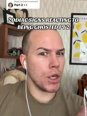 A bald, light-skinned individual with a slightly furrowed brow and visible eye contact looks directly at the camera. The person has light eyebrows, a small nose ring, and is wearing a neutral-toned shirt and wired earbuds. The background shows a shelf with items, a framed picture and a poster with lemons, with a natural light illuminating the setting.