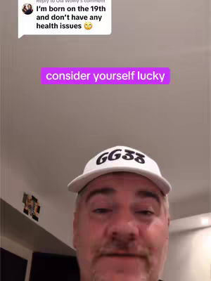 A selfie-style image featuring a man wearing a white cap with "GG38" printed on it. Above him, a speech bubble displays text from a comment, and a purple box with white text that says consider yourself lucky is over his head. The background is plain with some ceiling elements visible.