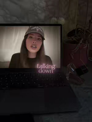 A person is displayed on a laptop screen, facing the camera and speaking. Text that reads 'talking down' is overlaid on the video of the laptop screen.
