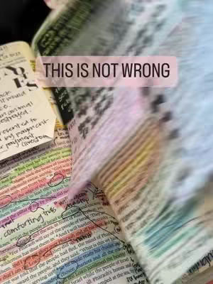 Close-up of an open Bible with highlighted and annotated text. The image is slightly blurred, with a pink overlay indicating a text box.