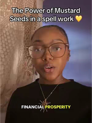 A woman with glasses is centered in the frame, presenting to the camera. Above her is white text overlayed with 'The Power of Mustard Seeds in a spell work' and below her is yellow text saying 'FINANCIAL PROSPERITY.' The background is a blurred interior with a beige patterned curtain.