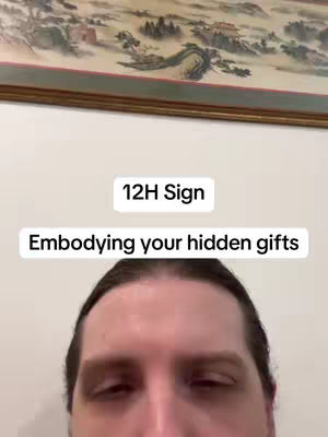 The cover image presents a mid-shot of a man's face, with a plain wall in the background. At the top, there's a framed painting. Two text overlays are prominent: '12H Sign' in a white rectangular box and 'Embodying your hidden gifts' in a similar box. The man's forehead and part of his eyes are visible, and the overall composition is simple, drawing focus to the text and the person.