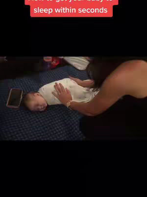 The cover image shows a woman's arm and part of her body in the frame, with a baby laying down on a bed. The baby has its eyes closed. In the top part of the frame, there is a red bar with the text "How to get your baby to sleep within seconds".