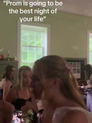 The cover image shows a group of young women, likely at a formal event like prom, with one person in the foreground partially obscuring the view. The background includes windows and a glimpse of the interior of a building, possibly a community hall or event space. There are text overlays that say Prom is going to be the best night of your life.