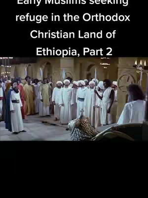 The cover image shows a scene from a movie. The image captures a group of people dressed in traditional white robes. Some are wearing turbans. They are standing inside a large, open hall, illuminated by soft lighting. The composition may imply a historical or religious context, with a focus on the narrative of early Muslims seeking refuge. In the background are archways and walls. The front features a richly decorated, ornate object draped with a gold color material.