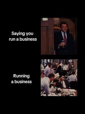 A split-screen meme using scenes from the movie "The Wolf of Wall Street." The top half shows Leonardo DiCaprio, dressed in a suit, giving a smug look while holding a glass. Text overlay reads "Saying you run a business." The bottom half shows a crowded office, filled with men in suits, appearing stressed and overwhelmed. Text overlay reads "Running a business." The background is black.
