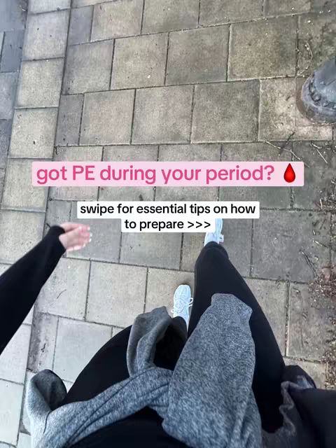 An overhead shot looking down at legs and feet. The person is walking on a brick path, wearing black or dark pants, gray hoodie, and light blue sneakers. Text overlays are visible on the brick path.