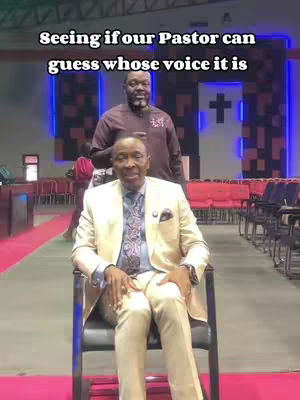 The cover image shows a man in a cream-colored suit seated in a chair inside a church. Behind him, another man stands, and the background reveals church decor. An overlay text states the video is seeing if the pastor can guess whose voice it is.