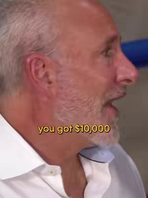 A man is shown speaking from the side, his face and upper body are visible. The man has short, grey hair and is wearing a white shirt and light blue undershirt. Overlayed text reads, "you got $10,000".