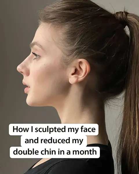 A woman's profile is shown in a close-up view, with her face angled to the side. She has brown hair pulled back into a high ponytail. The background is a plain, light gray. White text overlays the bottom of the image.