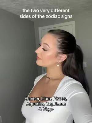 A woman with dark hair in a ponytail stands in profile, looking slightly upwards. She wears a white, scoop-neck top and a delicate necklace. Text overlays are present in the image, including the video's title and a list of zodiac signs.