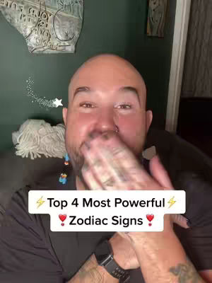 A man is shown from the chest up, with a hand covering his mouth. He is bald, with a nose piercing and tattoos on his arm. The background is a dark green wall with abstract art and a white fringed object. Overlayed white text reads 'Top 4 Most Powerful Zodiac Signs'.
