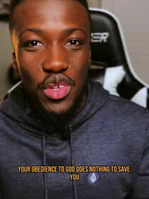 Close-up shot of a man speaking, wearing a gray hoodie, with text overlayed at the bottom.