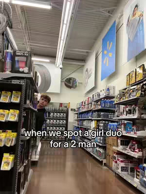 A young man peeks out from behind a shelf in a store, with aisles and a blue Walmart sign visible in the background. Text overlayed on the image communicates the video's content.
