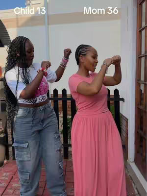 The cover image shows a mother and daughter dancing outdoors. The daughter, on the left, wears a white crop top, blue jeans, and has her hair in braids. The mother, on the right, is wearing a pink dress. They are dancing with their hands up.