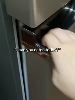 The image shows a hand opening what appears to be a cabinet or refrigerator door. The hand is in the foreground, with the door and surrounding frame in the background creating a sense of depth and is gray in color. The hook text is overlaid on the image, centered at the bottom of the view.