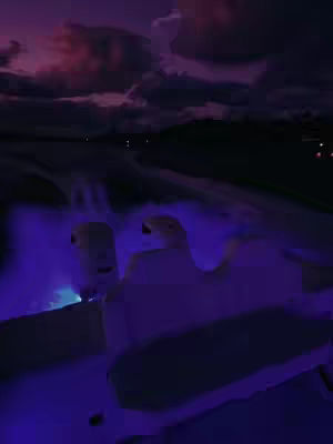 A night scene in a car, with a dark, purple-toned sky and dashboard lights lighting the interior.
