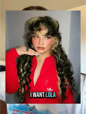A woman with long, wavy hair is the main focus, she is wearing a red Adidas top and has a ring on her index finger, with text overlayed that says 'I WANT LOLA'.