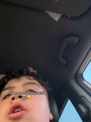The cover image shows an upward-angle view of a person's face inside a car. The person appears to be speaking. The background is of the car's interior, primarily the ceiling and side panel.