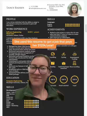 A woman with glasses is positioned in front of her resume, which is laid out on a black background. The resume includes her profile, work experience, skills, achievements and hobbies. Overlay text on the bottom text that highlights the woman's use of the resume to get a job paying her $125k/year, indicating the video's focus on career advice.