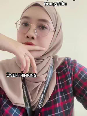 The cover image is a selfie of a woman with a hijab, round glasses, and a red and black plaid shirt. She has a finger on her lip and a ring on the finger of her other hand. A text overlay says 'OVERTHINKING'.
