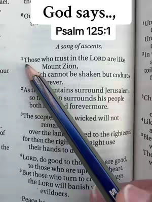 The cover image shows an open book with text and a pencil pointing to a specific verse. A text overlay at the top says "God says..." and Psalm 125:1