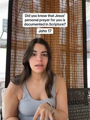 A woman with long dark hair is centered in front of a woven window covering. She is wearing a grey tank top and a watch, and looking towards the camera with an open mouth. Text overlay has been added at the top and a rectangular text at the bottom.