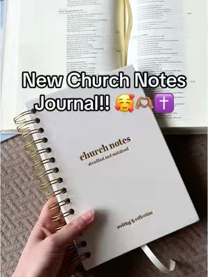 A hand holds open a spiral-bound notebook against the backdrop of an open book's pages. Text overlayed at the top reads 'New Church Notes Journal!!' with related emojis. The notebook cover is white with the title 'church notes' in a gold-toned font. The words 'steadfast and sustained' are right below the title with 'writing & reflection' at the bottom in a smaller font.