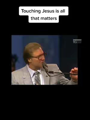 The cover image shows a man wearing glasses and a suit speaking into a microphone. Above him is a white banner containing the text 'Touching Jesus is all that matters'. The background suggests a stage or studio setting.
