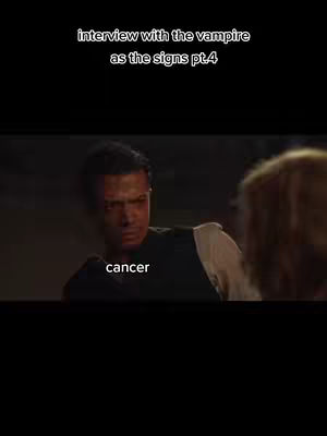 The cover image is a vertical shot from a scene in a film. The main subject, a man with short dark hair, is looking to the left and slightly down, with a focused expression, in a dimly lit setting. Text that reads 'cancer' is overlaid across the center of the image. The background is dark, suggesting an interior setting. The overall impression is one of drama and intensity. The text at the top says interview with the vampire as the signs pt.4