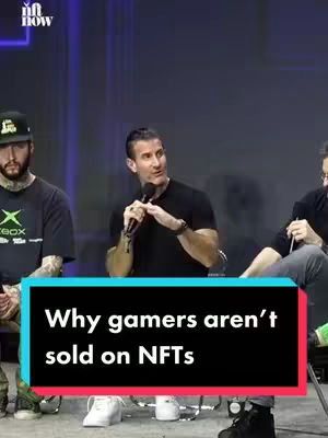 The image shows three men seated. In the foreground, a black box with white text overlays the image to declare: “Why gamers aren’t sold on NFTs.” The man in the center holds a microphone. The background appears to be a dark blue wall or screen.