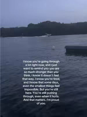 A serene image showing a body of water with a clouded sky. In the distance, there's a landmass lined with trees. A speedboat is moving across the water, and a portion of a structure or dock is near the right edge. Text is overlaid, conveying an emotional message.