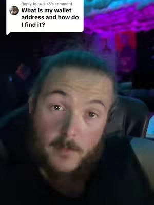 A man with a beard is centered with a commentary comment above. His face takes up most of the frame, illuminated with soft lighting. The background is blurred, with hints of purple and dark tones.